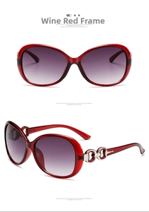 Close-up of wine red oversized sunglasses with gradient lenses and silver metal hinges