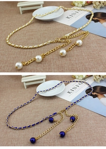 Detail of woven chain belt featuring gold alloy links with elegant large pearl charms