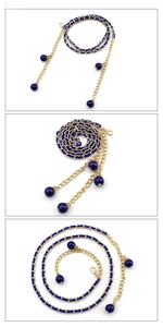 Detail of royal blue woven leather and gold metal chain belt with bead pendants