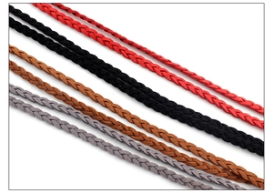 Detailed close-up of handmade woven waist chains in red, black, brown, and grey textures