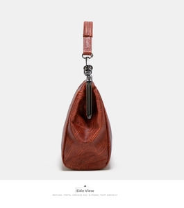 Side view of a vintage brown handbag showing its triangular shape and retro clasp detail