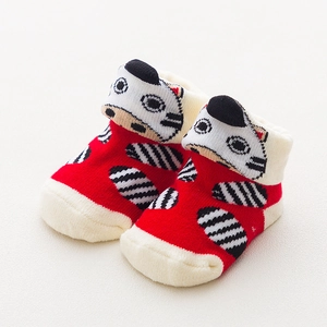 Detail of red baby socks with cute 3D zebra animal doll and white lace turnover cuff