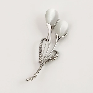 Elegant silver tulip brooch with white cat eye stones and sparkling rhinestones