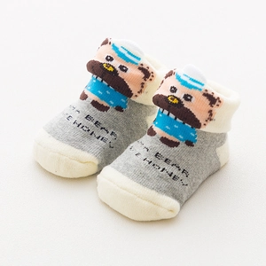 Detail of grey baby socks with cute cartoon bear pattern and Bear Honey text embroidery