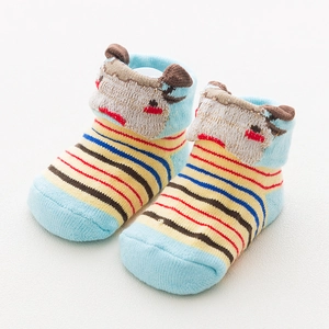 Close-up of baby socks featuring striped pattern and 3D cartoon deer head decoration