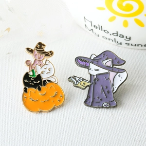 Halloween wizard cat enamel brooches featuring black and white kittens on orange pumpkins