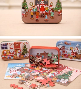 Detailed view of DIY Christmas puzzles in colorful tin boxes with Santa Claus patterns