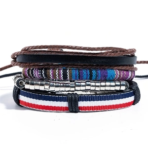 Ethnic handmade multilayer bracelet set with leather weaving and wooden beads in studio