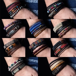 Detail view of multi-layer leather bracelets with wooden beads and woven charms