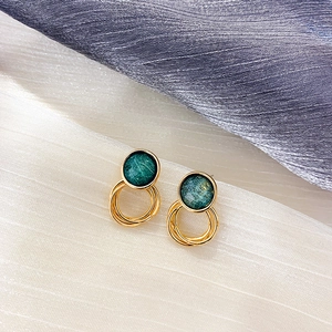Detailed view of vintage green brushed round stud earrings with golden textured metal hoops