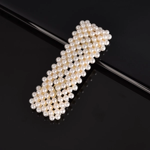 Close-up of elegant rectangular hair clip with multiple rows of small white pearls