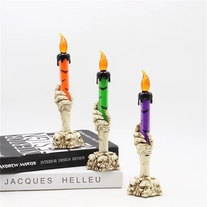 Halloween skull hand LED candle lamps in orange, green, and purple festive colors