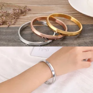 Close-up of three-tone gold pavé rhinestone bangles with rust-resistant brushed finish