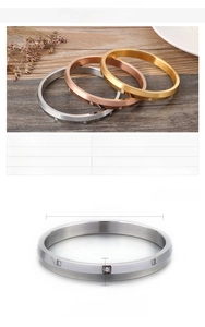 Detailed view of gold and silver zircon inlaid stainless steel bangles with size specs