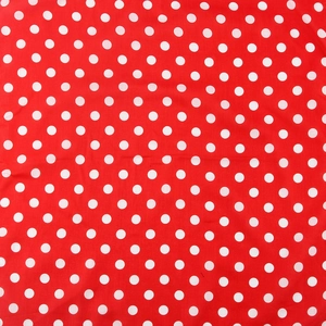 Detailed close-up of classic red and white polka dot pattern on soft cotton bandana fabric