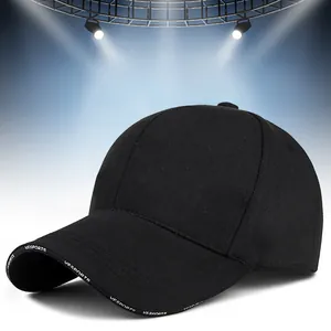Detail of the black cotton baseball cap showing white VESPORTS lettering on the brim edge