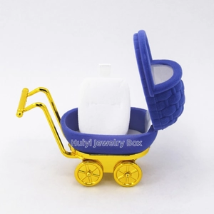 Detailed view of baby stroller jewelry box with blue velvet and gold electroplated accents