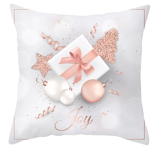Gros plan du motif festif Joy or rose et du coffret cadeau sur la taie d'oreiller