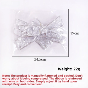 Macro shot of silver mesh Christmas bow with star patterns and size 24.5cm x 19cm