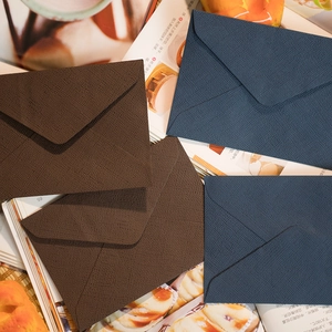 Buste di lusso con trama di lino in blu navy e marrone caffè in carta speciale