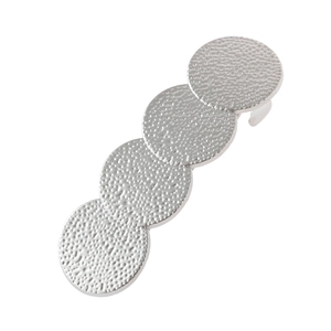 Détail d'une barrette géométrique argentée avec quatre disques en métal martelé texturé
