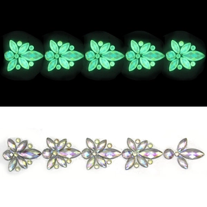 Luminous floral resin crystal gems showing silver iridescent glow and green night light