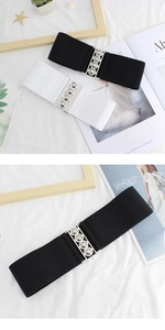 Detail of black and white elastic waist belts with silver metallic buckle on props