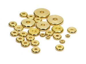 Flat solid brass spacer beads for DIY jewelry making in various sizes on white surface