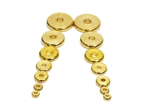 Flat solid brass spacer beads for jewelry making displayed in various sizes on white