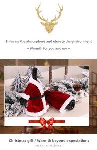 Detailed view of red velvet Santa suit wine bottle covers with white faux fur and belts