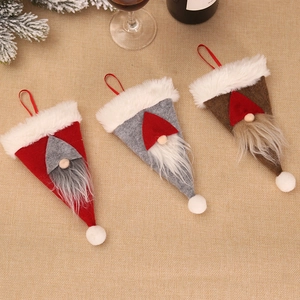 Three-piece Christmas forest gnome cutlery bags in red, gray and brown on linen
