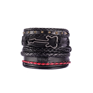 Close-up of multilayer leather bracelet featuring metal guitar charm and red woven rope