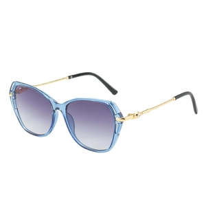 Lunettes de soleil œil-de-chat bleues avec verres dégradés violets et branches dorées