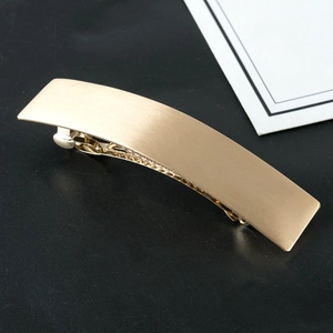 Minimalist gold rectangular hair clip with brushed metal finish and spring clip design