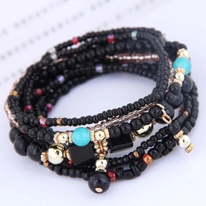 Bohemian multilayer beaded bracelet with black and gold beads in chic stacked style