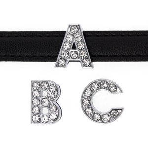 Macro shot of 10mm silver alloy slide letters A, B, and C with sparkling white rhinestones