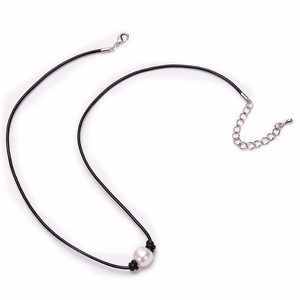 Minimalist natural freshwater pearl necklace with black leather cord on white background