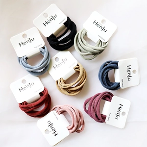 Close-up of chic elastic hair bands in assorted colors organized on a white surface