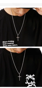 Close-up of stainless steel cross pendant necklaces in silver and gold on a model
