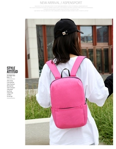 Pink minimalist backpack featuring durable oxford cloth and adjustable straps on a model