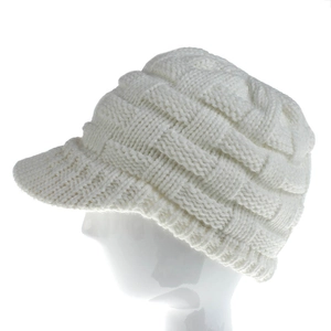 Detailed knit texture of white winter beanie with visor on mannequin head