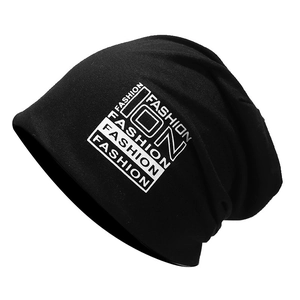Detail of black slouchy cotton beanie featuring white FASHION letter prints in a grid style