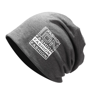 Dark grey knitted slouchy beanie with white FASHION lettering on a white background