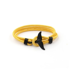 Adjustable yellow woven cord bracelet featuring a black whale tail anchor charm on white background
