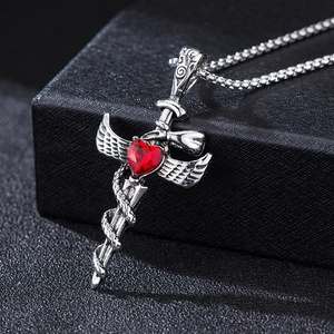 Gothic silver cross necklace with red heart gemstone and serpent wings design