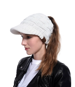 Close-up of white cable knit ponytail baseball cap with leather MOK label detail