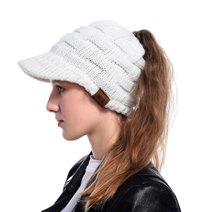 Side view of a white knitted ponytail baseball cap for women with MOK leather label