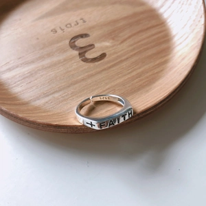Macro shot of S925 sterling silver ring featuring Faith engraving and cross symbol