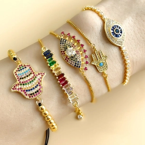 Detailed layered Hamsa and Evil Eye bracelets with colorful cubic zirconia stones