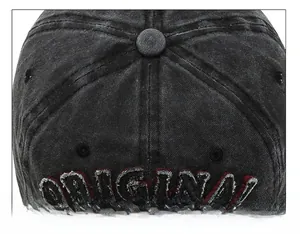 Detail of gray ORIGINAL 3D embroidery and stitching on a black washed denim baseball cap